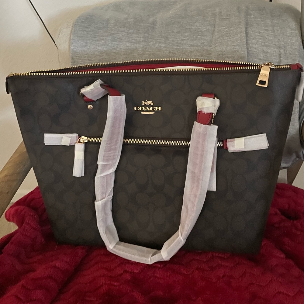 Coach Gallery Tote brown with red on the inside and brown on the outside.